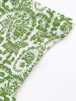 Green patterned fabric on a white background