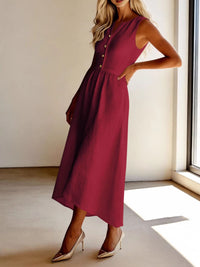 Woman wearing a burgundy dress with buttons in a bright room.