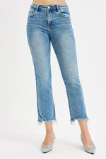 Light blue jeans worn by a person on a white background
