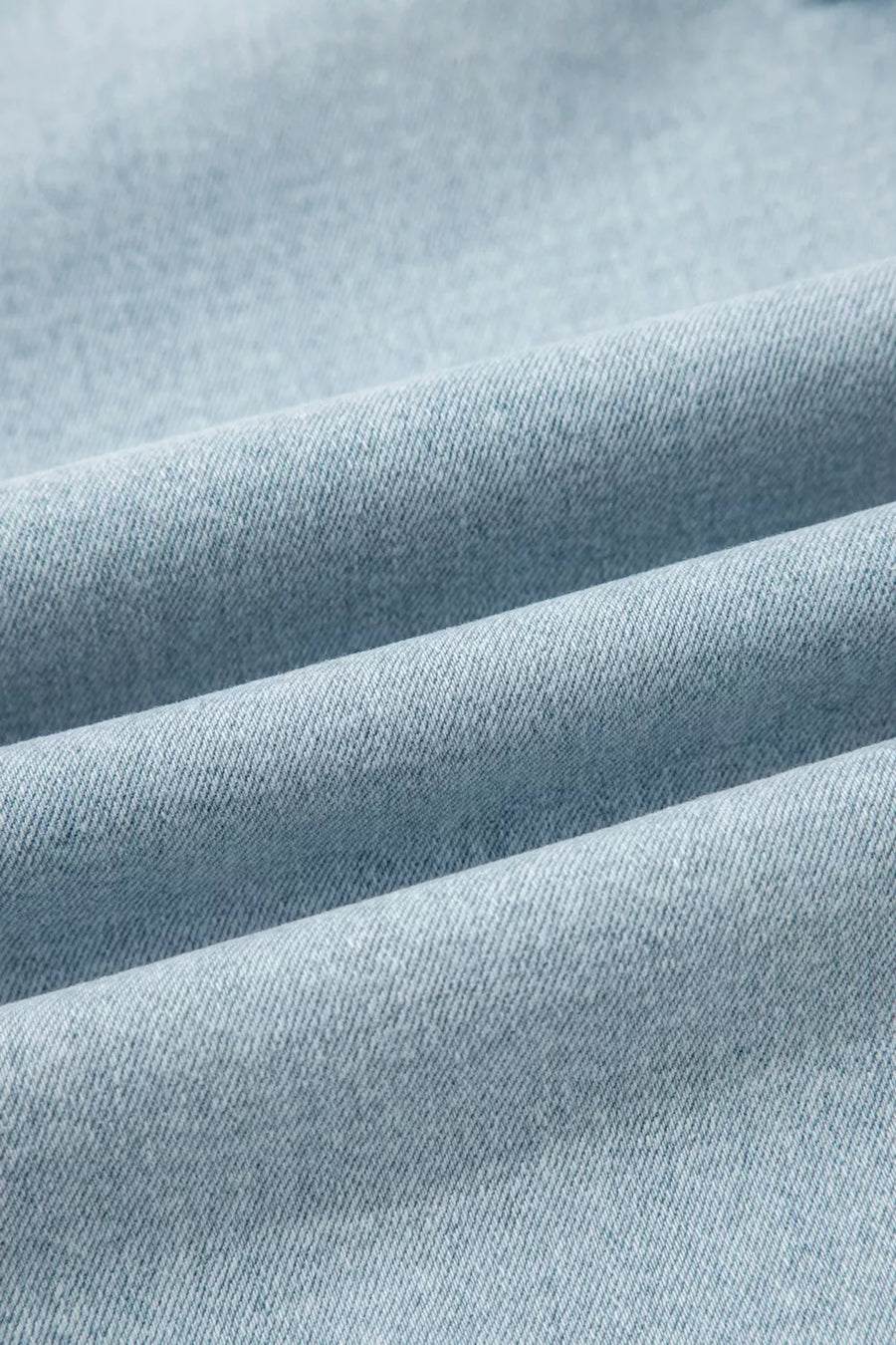 Close-up of light blue fabric with visible texture