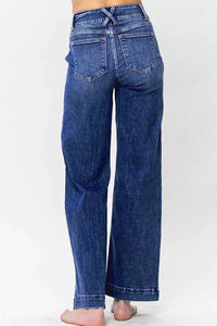 Lady showing the back of Blue jeans on a white background