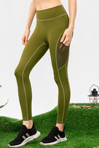 Person wearing green leggings with a white background