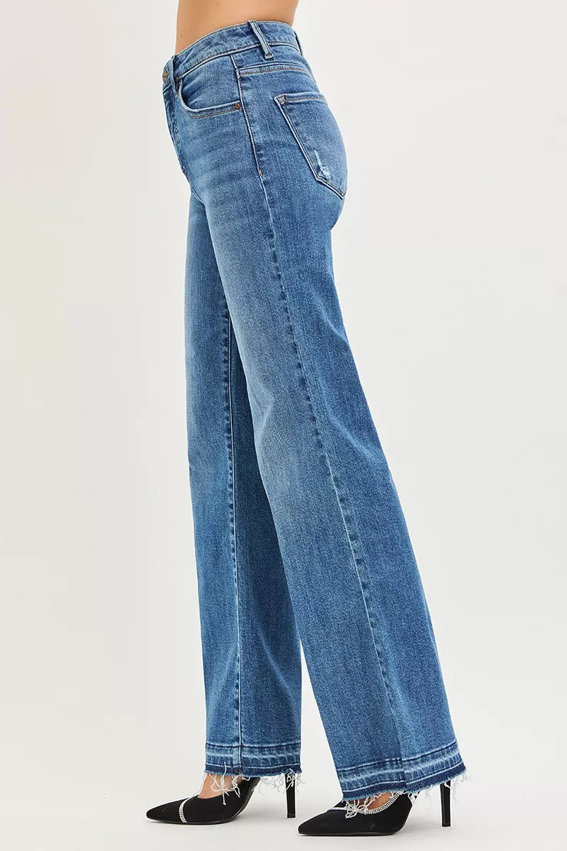 Blue jeans worn by a person on a white background