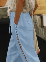 Light blue apron with decorative trim worn by a person, blurred background