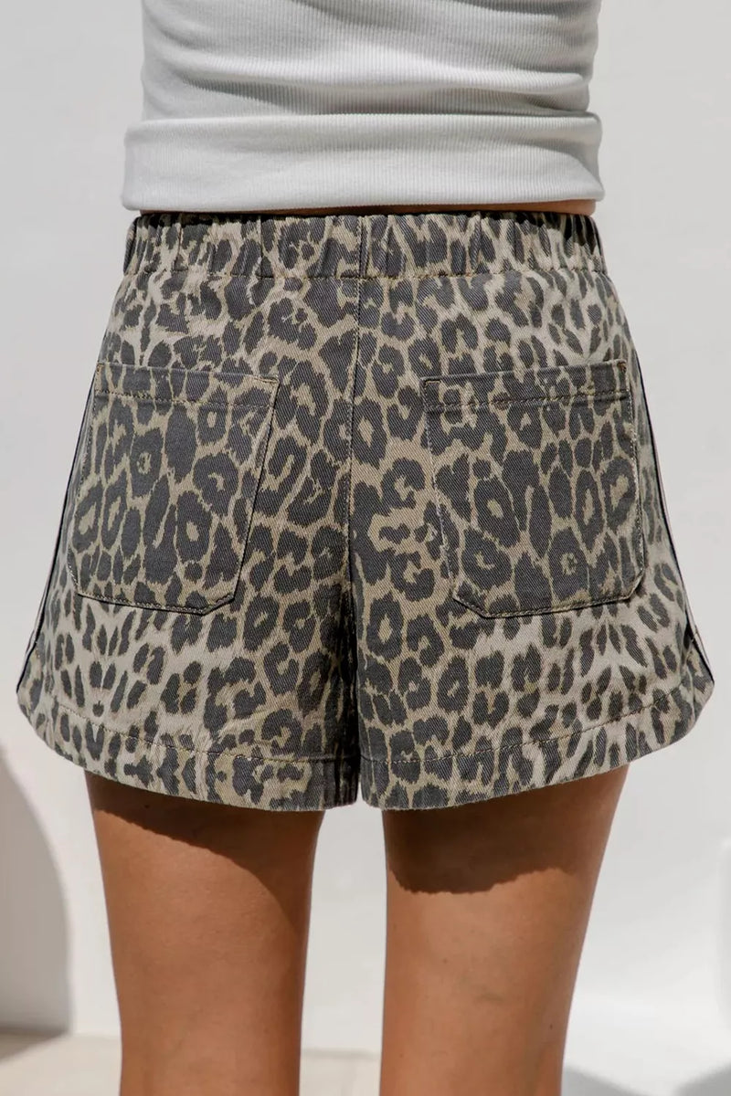Leopard print shorts worn by a person against a light background