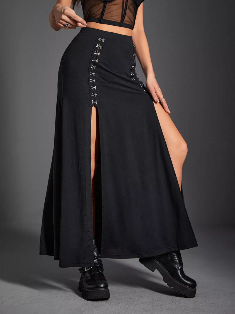 Black skirt with cut-out side panels worn by a person on a gray background