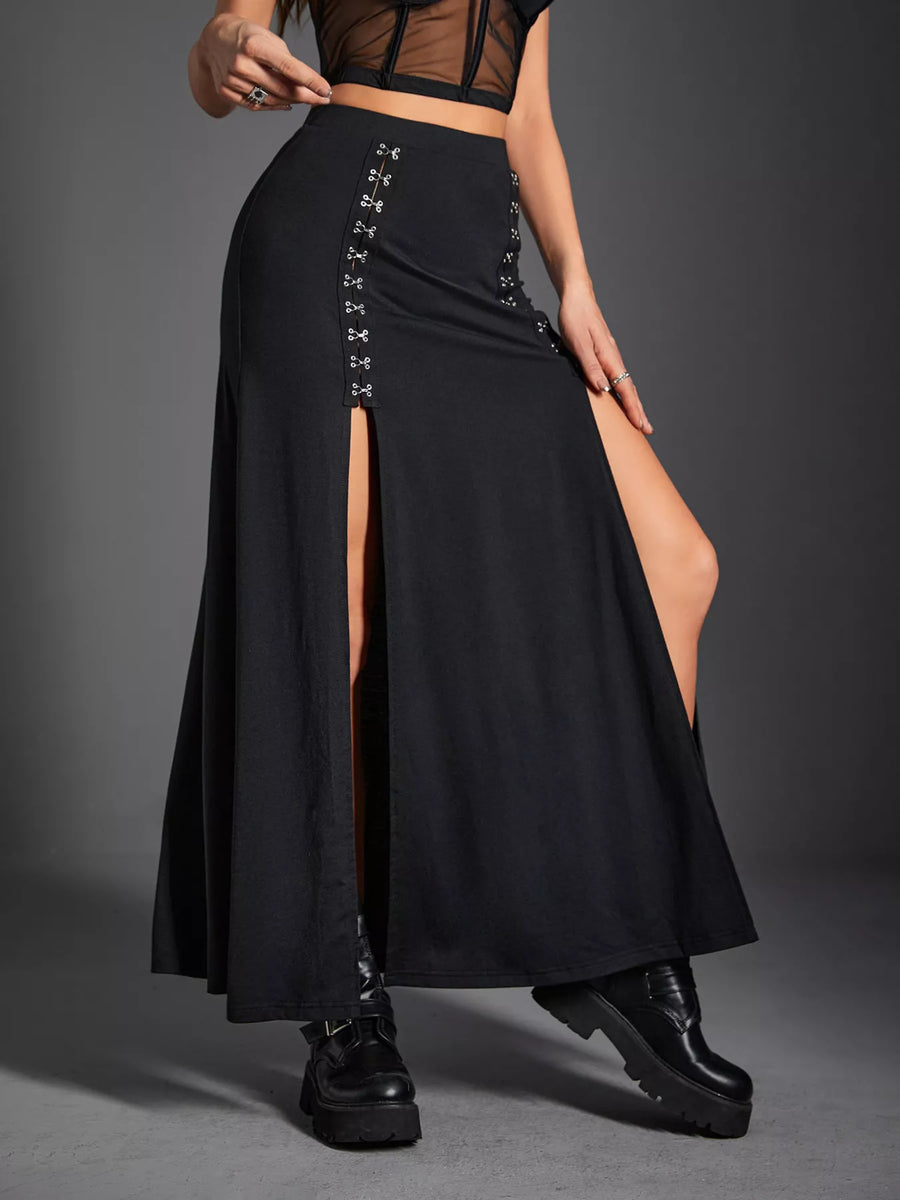 Black skirt with cut-out side panels worn by a person on a gray background