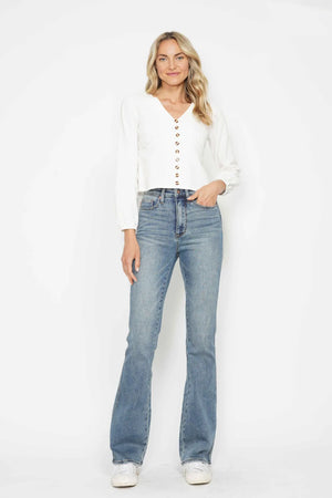 Woman wearing a white blouse and blue jeans on a white background