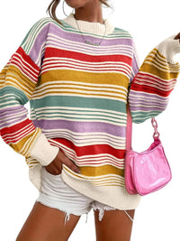 Person wearing a colorful striped sweater and holding a pink handbag.