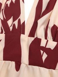 Close-up of a garment with maroon and beige abstract pattern