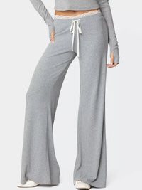 Gray lounge pants with a drawstring waist on a white background