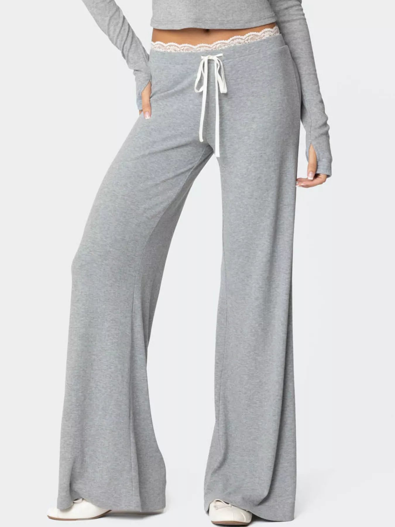 Gray lounge pants with a drawstring waist on a white background