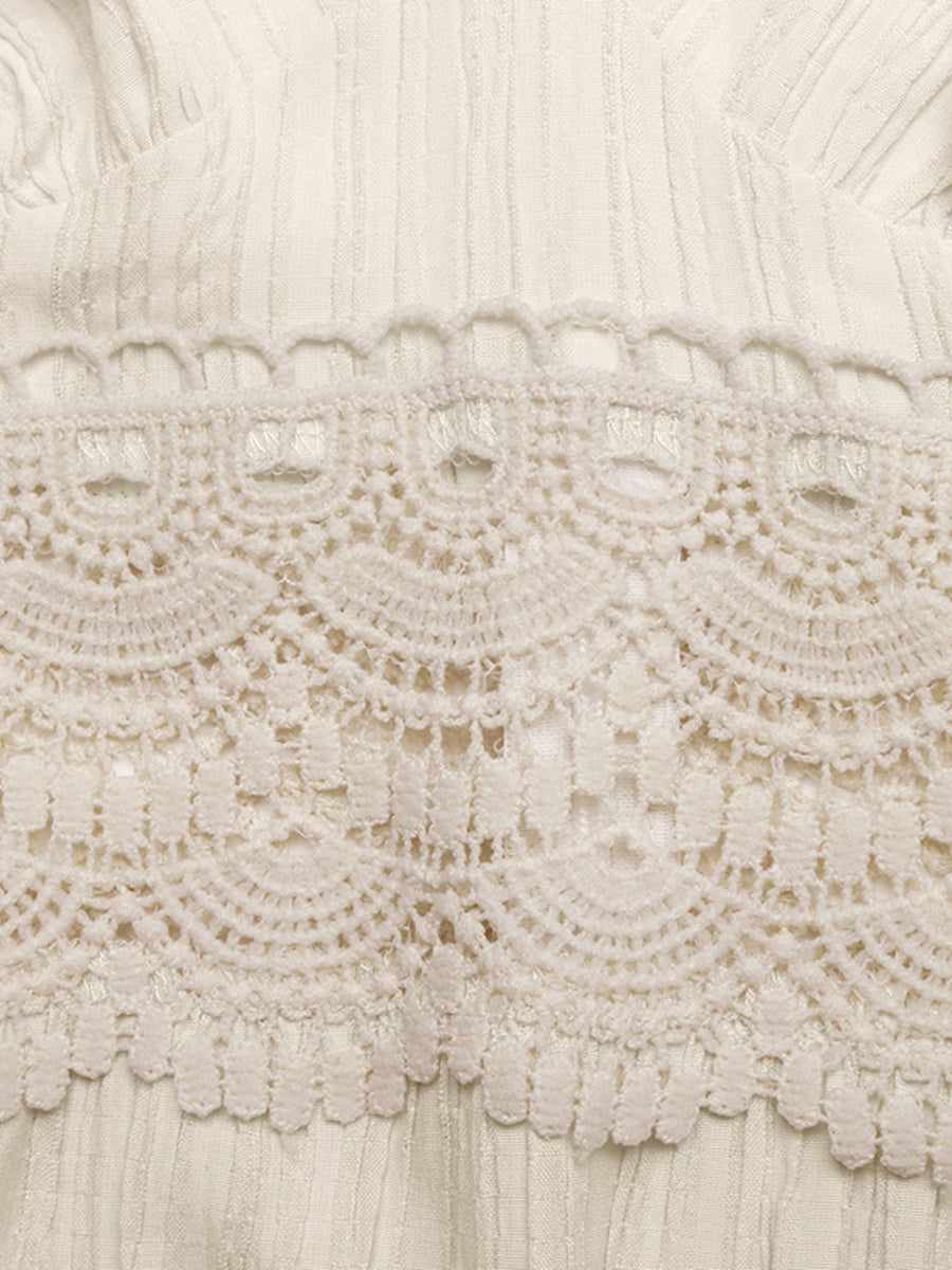 Close-up of intricate lace fabric with a neutral color palette.