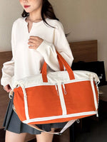 Person holding an orange and white bag indoors