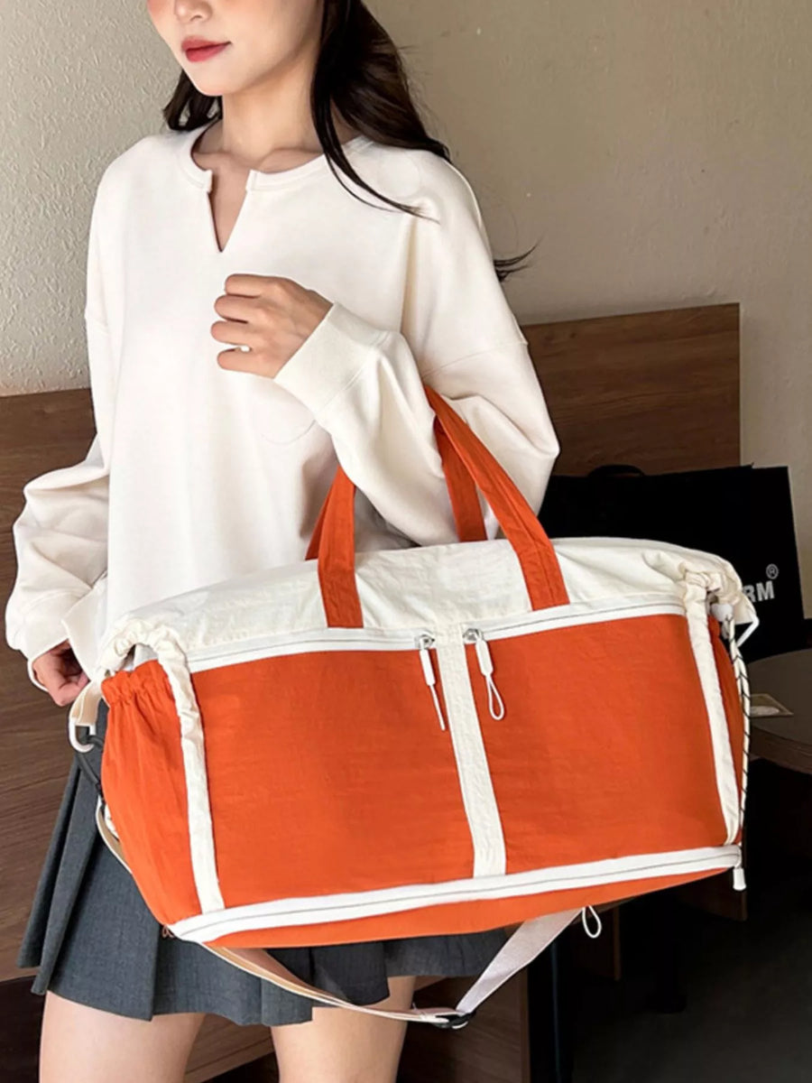 Person holding an orange and white bag indoors
