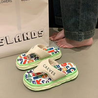 Colorful sandals with letter patterns on a neutral background