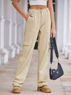 Person wearing beige cargo pants holding a black Prada handbag.