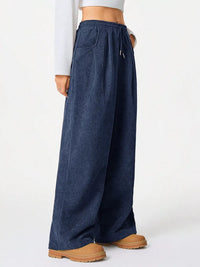 Blue wide-leg pants worn by a person on a white background