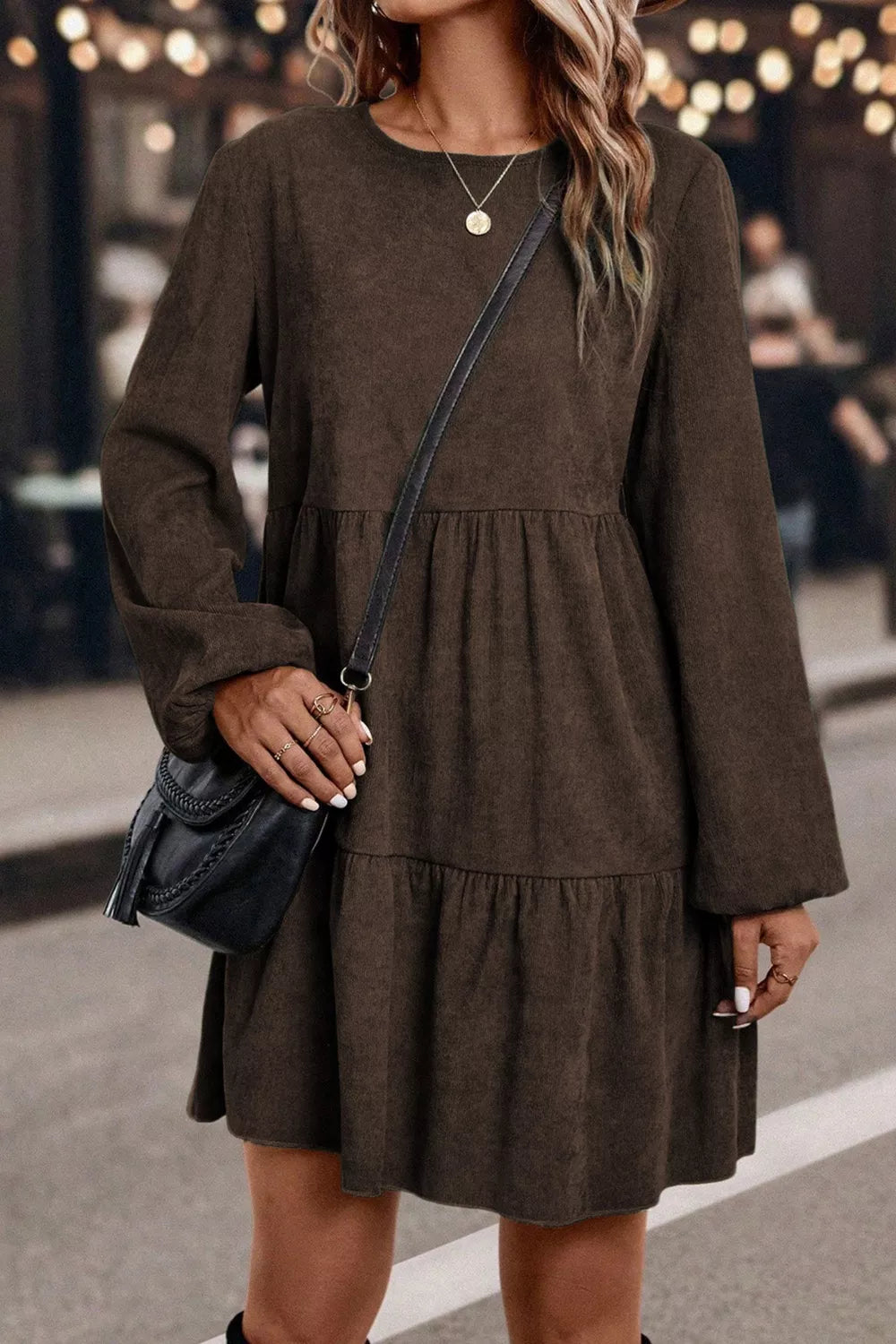 Woman wearing a brown dress with a blurred background