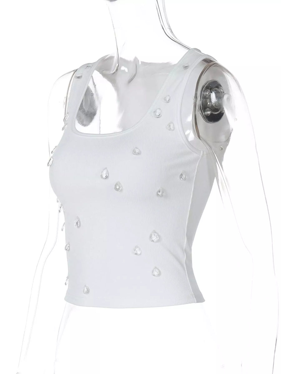 White sleeveless top with pearl embellishments on a white background