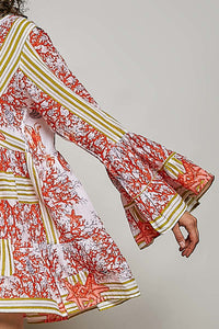 Floral patterned dress with long sleeves on a plain background