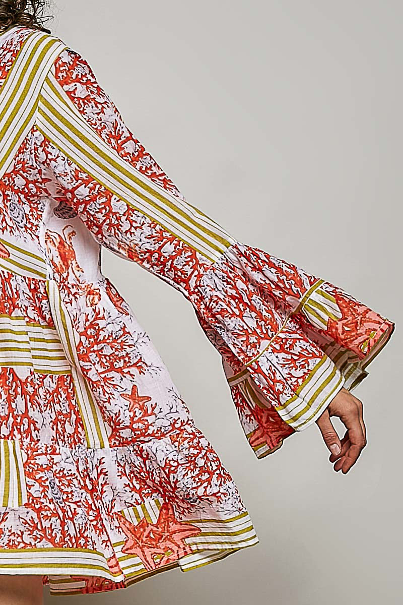 Floral patterned dress with long sleeves on a plain background