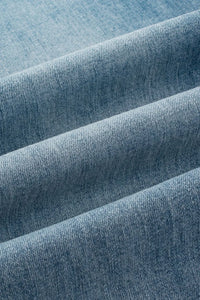 Close-up of blue denim fabric with a subtle pattern