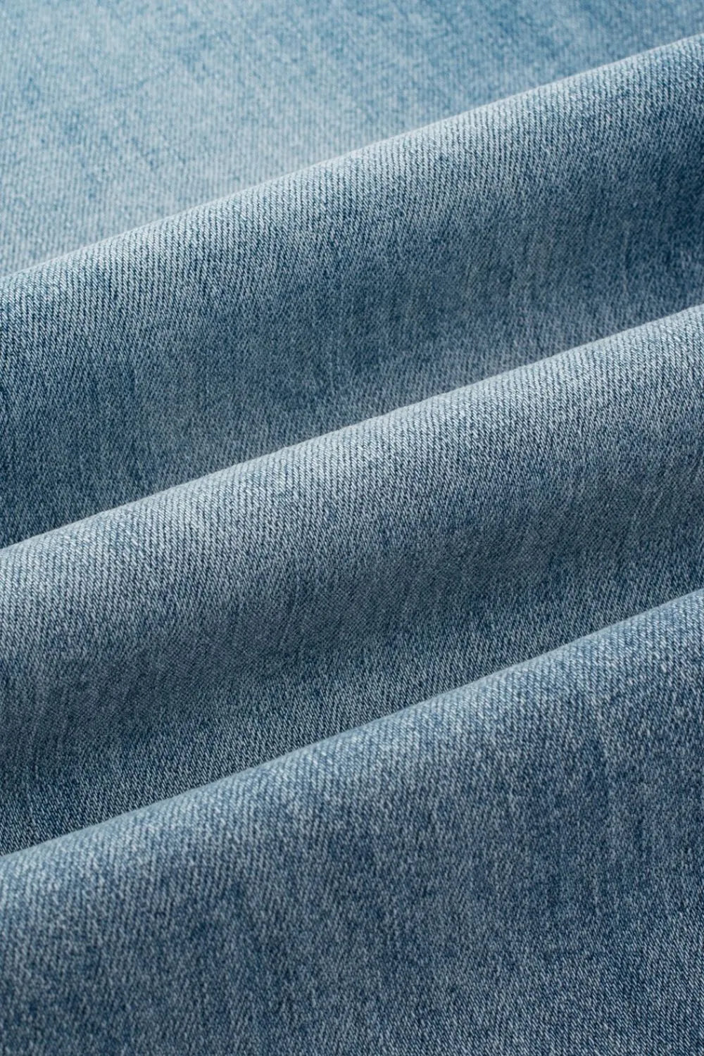Close-up of blue denim fabric with a subtle pattern
