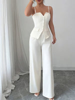 White jumpsuit with a blazer top worn by a person against a neutral background
