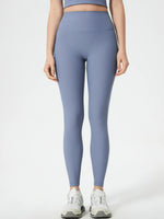 Person wearing light blue leggings on a white background