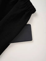 Black fabric and black mat on a white surface