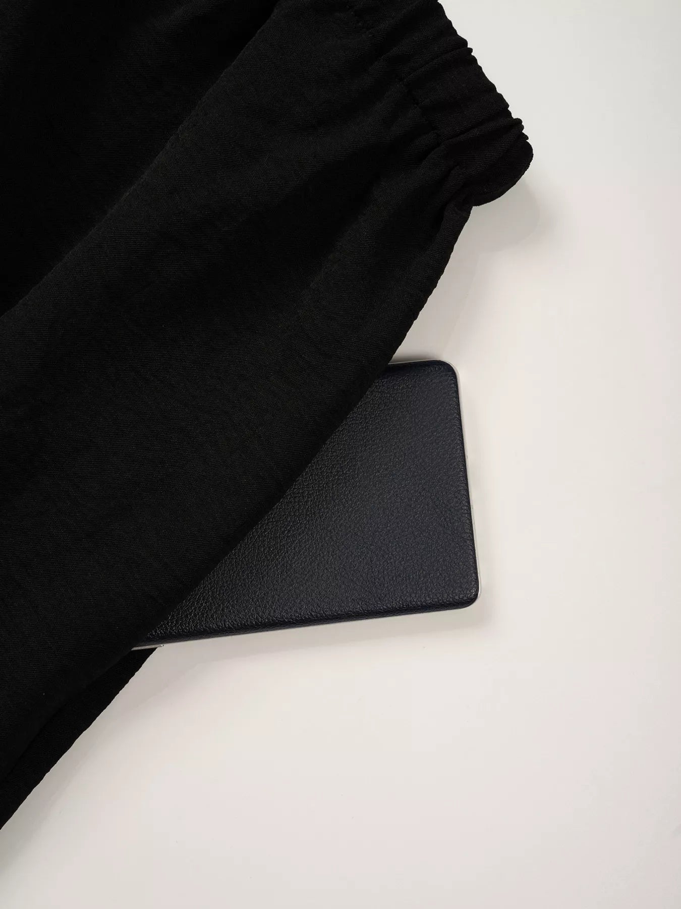 Black fabric and black mat on a white surface