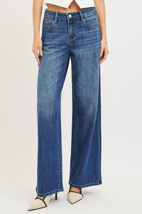Blue jeans worn by a person on a white background