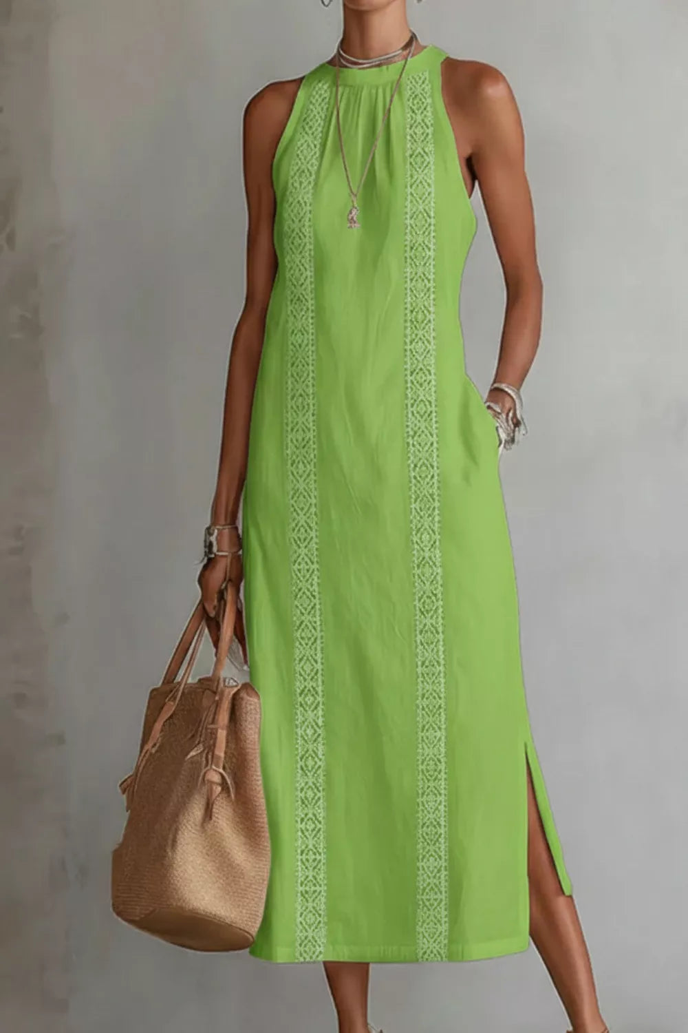 Woman wearing a green dress with a brown bag against a gray background