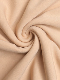 Close-up of beige fabric with a swirl pattern