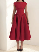 Red dress worn by a person on a plain background