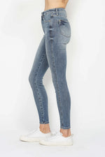 Light blue jeans worn by a person on a white background