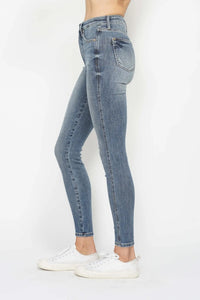 Light blue jeans worn by a person on a white background