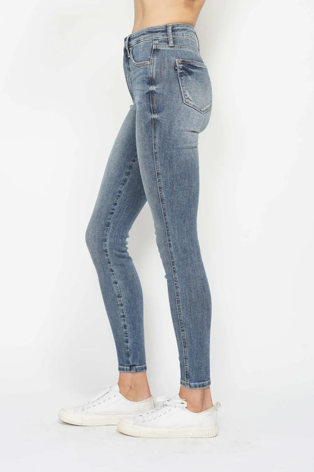 Light blue jeans worn by a person on a white background