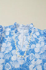 Blue and white floral patterned fabric on a beige background