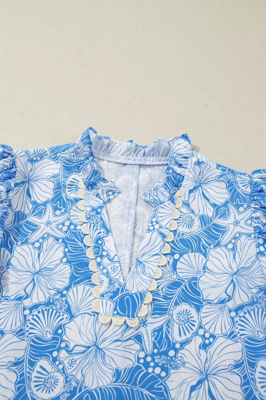 Blue and white floral patterned fabric on a beige background