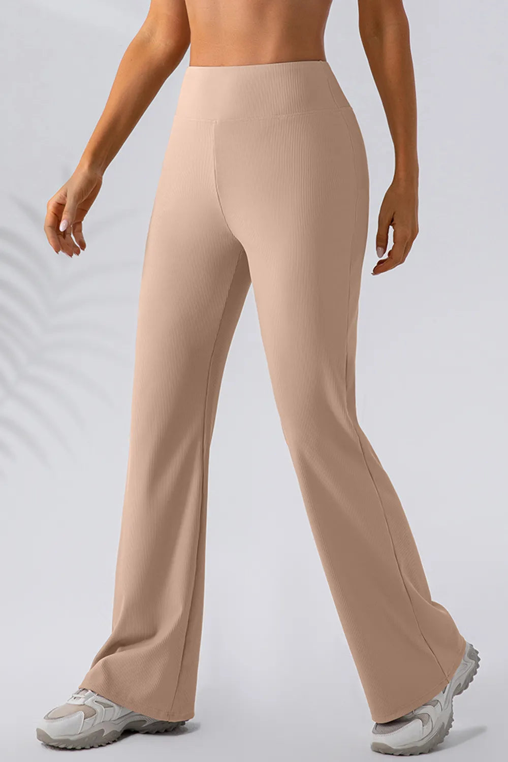 Beige pants worn by a person on a light gray background