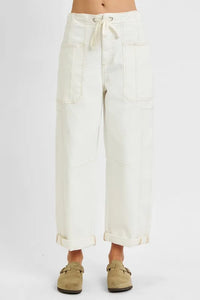White wide-leg pants worn by a person on a white background