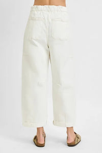 White pants worn by a person on a white background