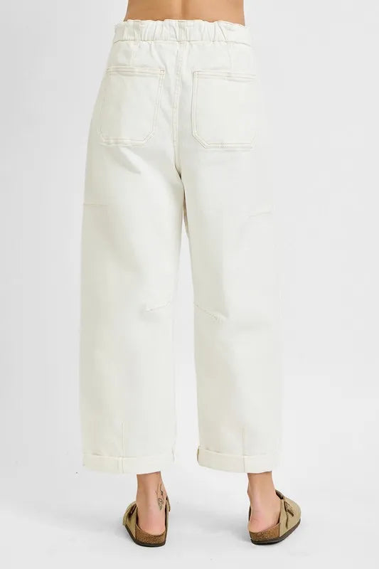 White pants worn by a person on a white background