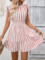 Woman wearing a pink and white striped dress against a wooden background