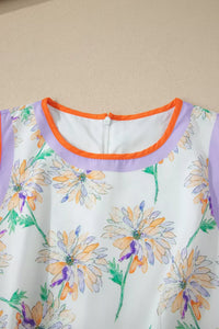 Close-up of a floral dress with a purple neckline against a beige background