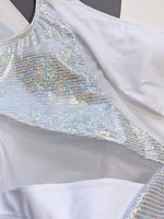 Close-up of a silver sequin dress with a plain background