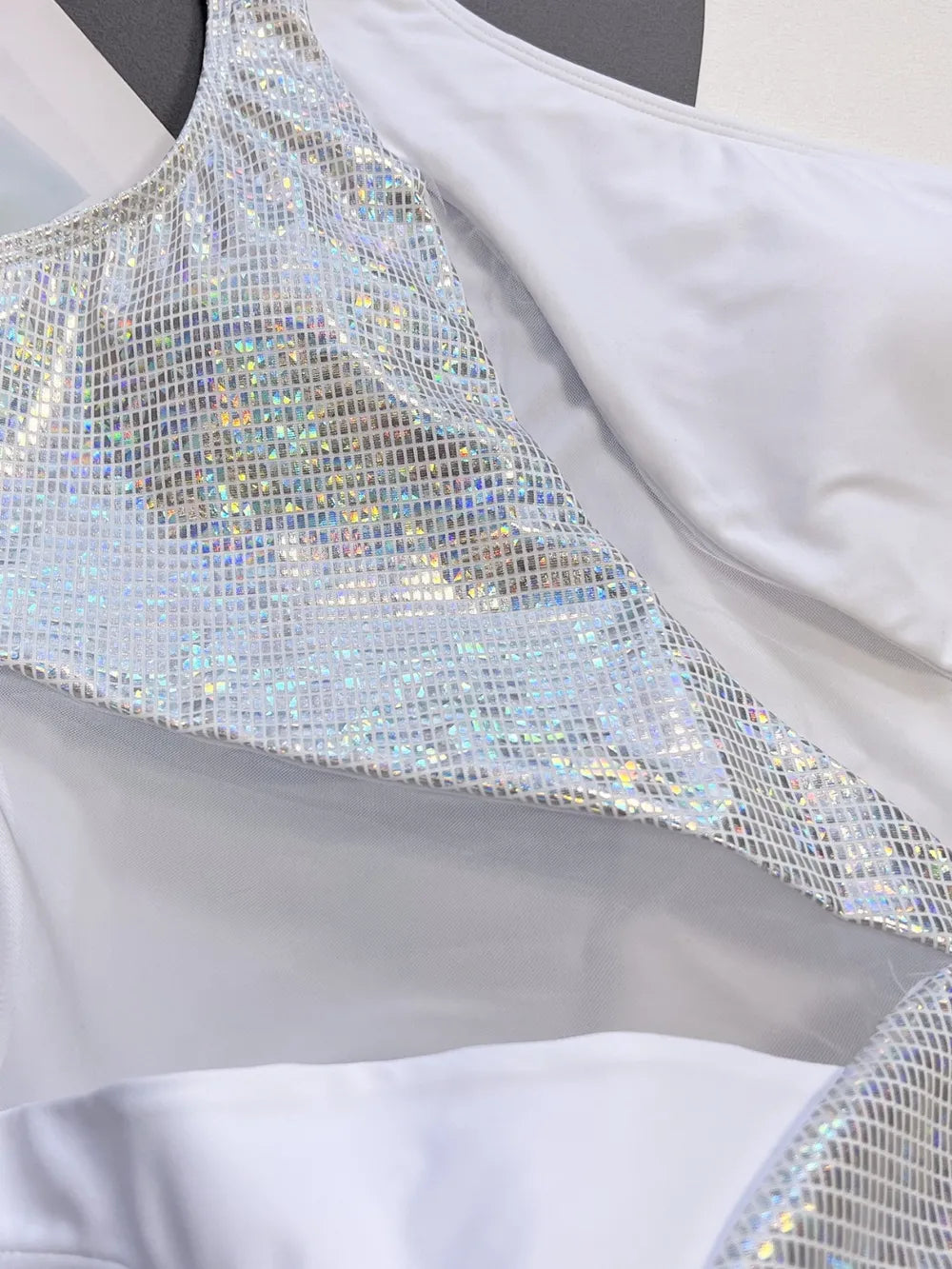 Close-up of a silver sequin dress with a plain background