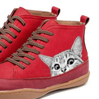 Red high-top sneakers with a cat design on a white background